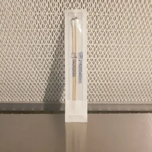 Sealed sterile spore swab in its packaging in front of a laminar flow hood filter