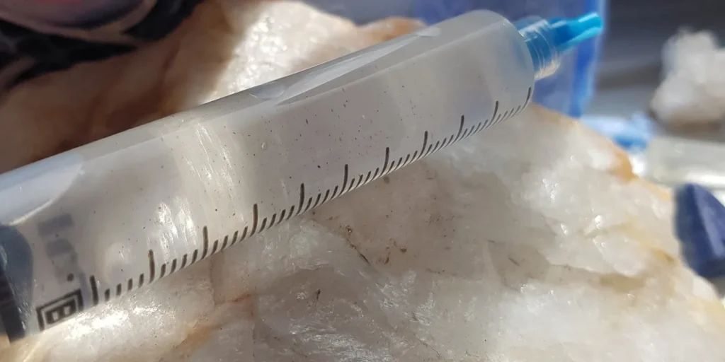 Close-up of a filled 10cc spore syringe